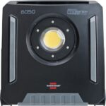 Projecteur LED de chantier noir sur batterie avec poignée intégrée et panneaux latéraux lumineux
