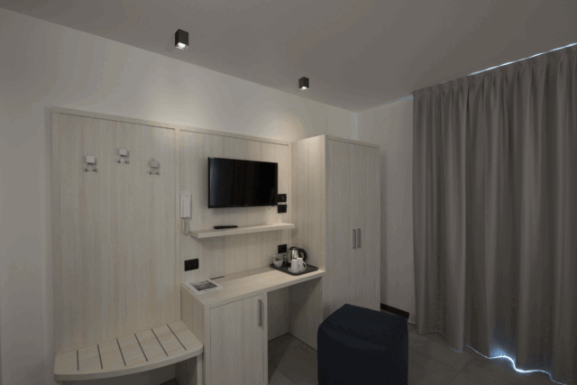 Plafonnier cube noir fixé au plafond avec intérieur clair dans une chambre moderne